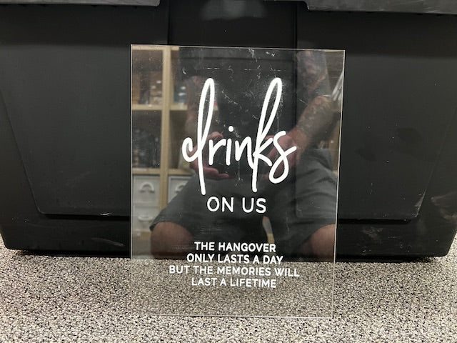 Clear drinks on us sign.